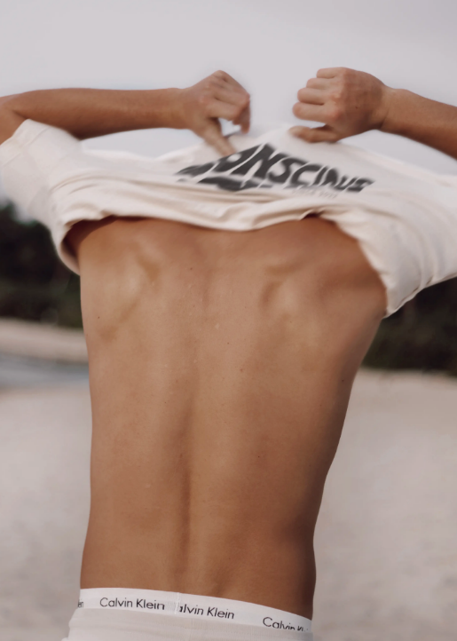 Back view of a boy wearing his Conscious Club White T-Shirt